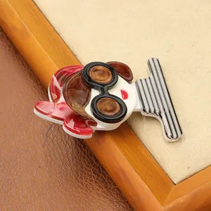 Detailed macro view of acrylic fashion brooch featuring a girl in striped outfit and goggles