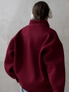 Detailed back view of a burgundy oversized fleece-lined half-zip sweatshirt for women
