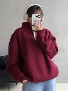 Oversized burgundy half-zip fleece sweatshirt for women shown in a lifestyle model photo