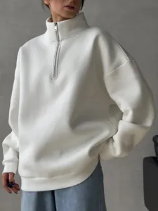 Detail view of the thick white oversized half-zip sweatshirt showing collar texture