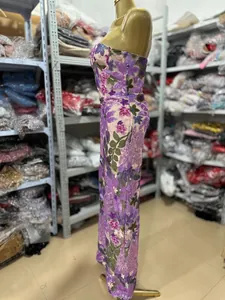 Side view of a floral embroidered strapless evening gown displayed on a gold mannequin