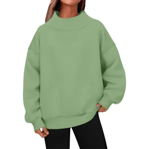Close-up of a cozy oversized mock neck long sleeve pullover sweatshirt in sage green for women