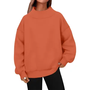 Detailed view of an oversized orange mock neck sweatshirt featuring ribbed cuffs