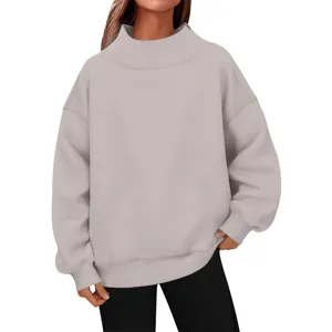 Close-up detail of a comfortable beige oversized turtleneck sweatshirt for women.