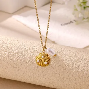 Close-up detail of gold stainless steel shell pendant necklace with a baroque pearl