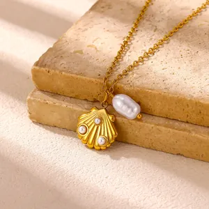 Detailed close-up of a gold shell pendant with small pearls on a beach style necklace