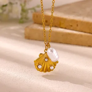 Close-up detail of a golden stainless steel shell pendant necklace with elegant pearls