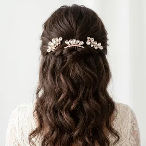 Close-up of elegant teardrop rhinestone hair comb set styled on wavy brunette hair