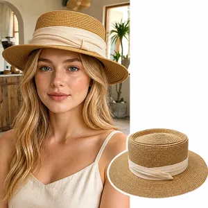 Classic French style straw sun hat featuring a wide brim and elegant beige ribbon band