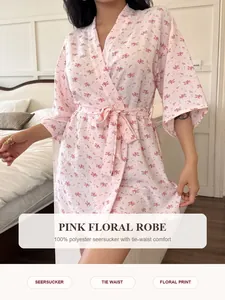 Close-up of pink floral seersucker robe for women featuring tie-waist and soft fabric texture