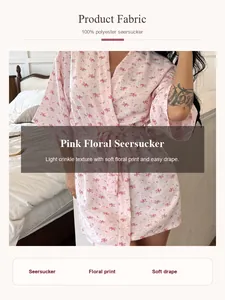 Detail view of pink floral seersucker bathrobe showing the soft crinkle fabric and print
