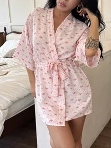 Close-up detail of a pink floral print seersucker cotton kimono robe for women's sleepwear