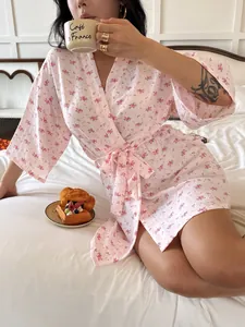 Soft pink floral cotton robe for women with seersucker texture in a cozy bedroom