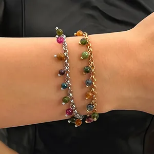 Detail of two layered bracelets with colorful gemstone beads on a model's wrist
