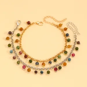 Detailed macro view of vintage gold and silver bracelets with multi-colored beads