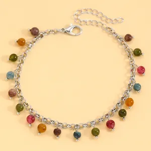 Detailed view of silver chain bracelet with colorful round stone beads and lobster clasp