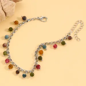 Close-up view of vintage silver chain bracelet with colorful round gemstone beads detail