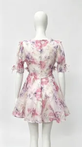 Back view of French style floral print dress with puff sleeves and tie details