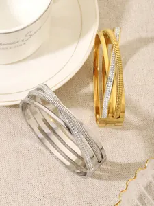 Detailed view of layered crossover bangles with crystal inlay and 18K gold plating finish