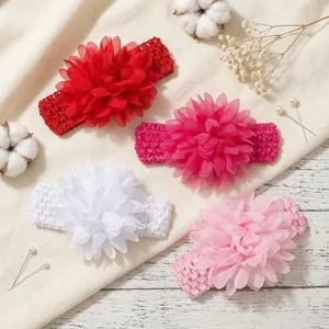 Detailed view of four colorful chiffon flower elastic headbands for baby girls