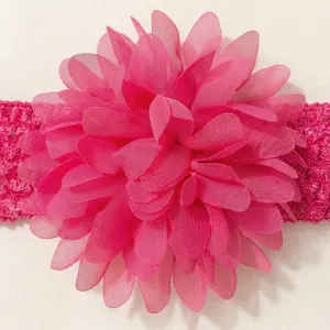 Close-up detail of vibrant pink chiffon flower on children's elastic headband