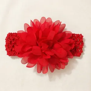 Close-up of a vibrant red chiffon flower headband with an elastic crochet band for babies.