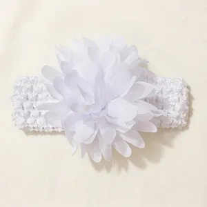 Detailed view of the delicate white chiffon flower on a stretchy knit baby headband