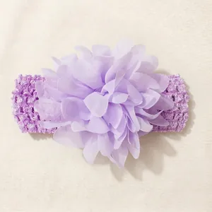 Detailed close-up of a soft purple chiffon flower on an elastic crochet baby headband