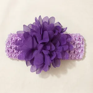 Macro detail of a purple chiffon flower on a soft elastic baby headband.