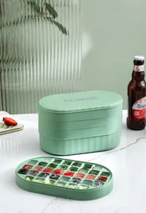 Close-up of mint green silicone ice cube tray set with frozen colorful fruit ice cubes