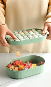 Macro detail of the flexible green silicone ice cube tray featuring easy push release mechanism
