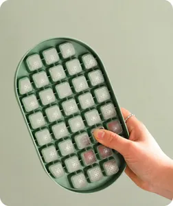 Close-up of flexible silicone bottom ice cube tray demonstrating easy ice cube release