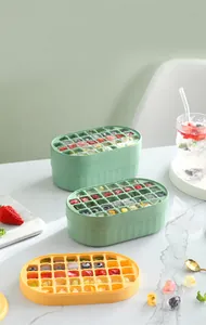 Close-up of multi-layer silicone ice cube trays with colorful fruit-filled ice cubes