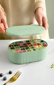 Close-up of green ice cube tray filled with colorful fruit-infused ice cubes.