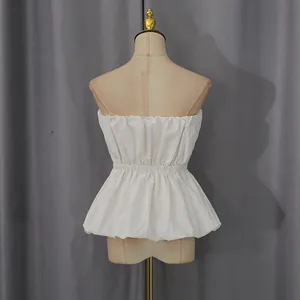 Detailed view of a white strapless peplum top featuring an elastic waist design on a mannequin