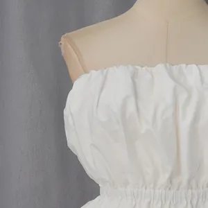 Close-up detail of a white ruffled strapless tube top featuring an elasticated waistline