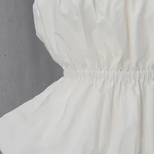 Detailed close-up showing the elastic waist and pleated fabric of a white tube top