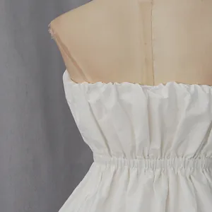 Detailed macro view of white strapless top with gathered elastic waist on mannequin torso