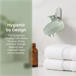 Detail view of wheat straw scalp massager hanging on a bathroom hook for hygienic storage.