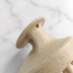 Macro detail view of an eco-friendly wheat straw hair massage brush handle with hanging hole