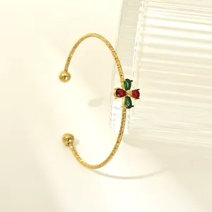 Gold titanium steel open bangle featuring red and green zircon floral motif close-up