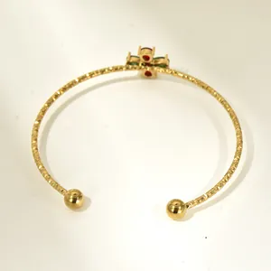 Detailed back view of gold titanium cuff bracelet with colorful zircon cross setting