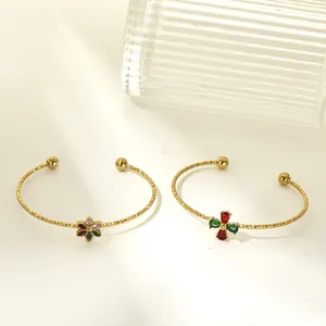Detailed view of gold-plated titanium steel bangles featuring colorful zircon flowers