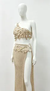 Detail of handmade crochet beach set with shell accents and high-slit mesh skirt