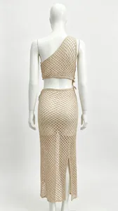 Back view of a beige one-shoulder crochet crop top and split mesh maxi skirt set