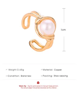 Gold C-shaped ear cuff featuring a central pearl and 1cm diameter specification