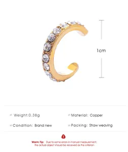 Detailed view of gold C-shaped ear cuff with clear rhinestones and 1cm height scale
