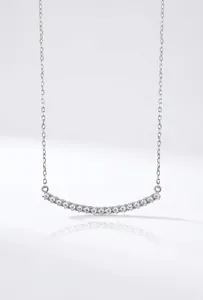 Detail of S925 sterling silver smile necklace with curved zirconia-set pendant.