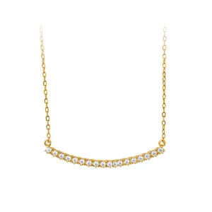 Close-up of a gold-plated silver necklace with a curved sparkling zircon smile bar