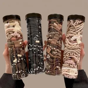 Variety set of neutral colored hair ties and scrunchies in four transparent jars